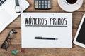 Spanish Text numeros primos prime numbers on note pad at offic